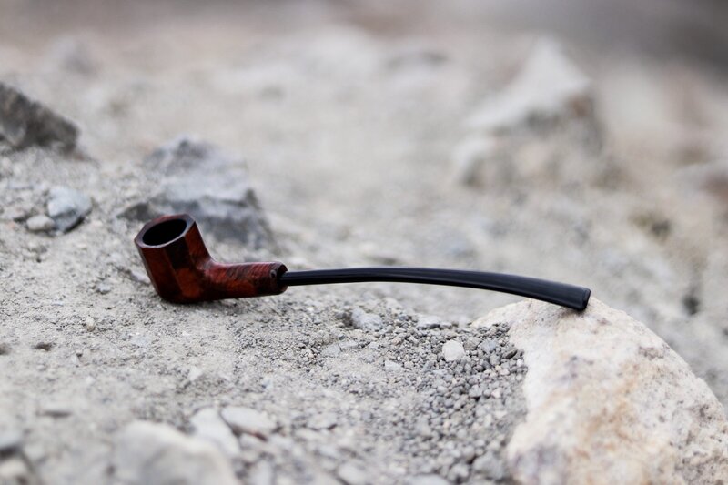 Wooden Pipe on Rocks