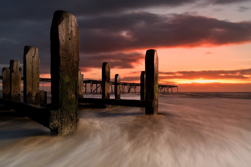 Wooden Posts at Sunset — Orange, Dramatic