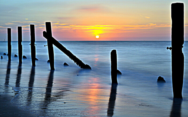 Wooden Posts at Sunset — Orange, Serene