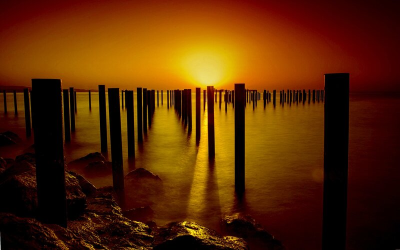 Wooden Posts at Sunset — Orange