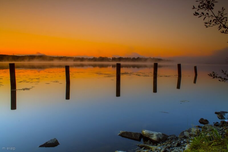 Wooden Posts in Lake — Orange