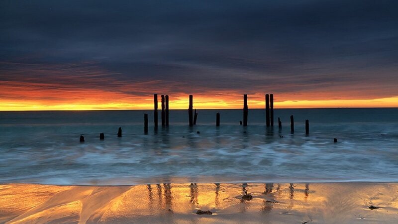 Wooden Posts in Ocean — Orange