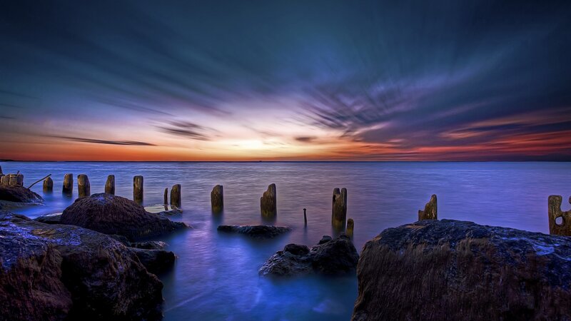 Wooden Posts in Water — Blue, Dramatic, Sunset, Photograph, Rocks