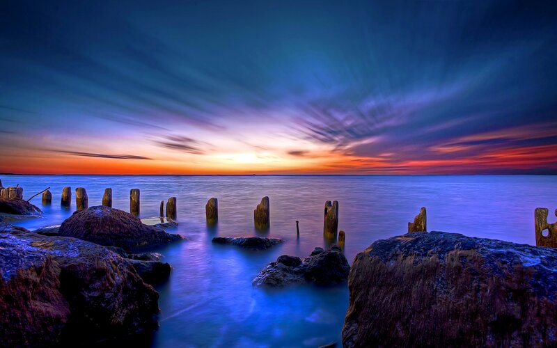 Wooden Posts in Water — Blue, Dramatic, Sunset