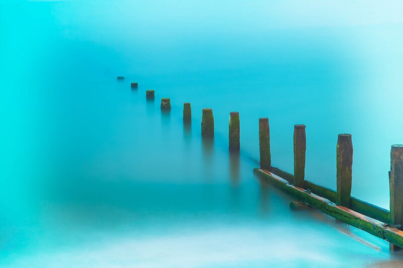 Wooden Posts in Water — Blue, Serene, Photograph