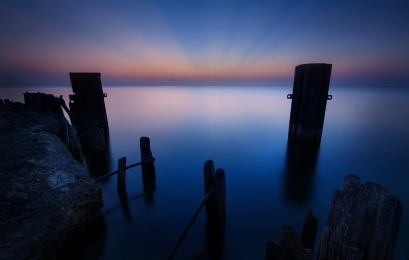 Wooden Posts in Water — Blue, Serene, Sunset, Photograph, Sea