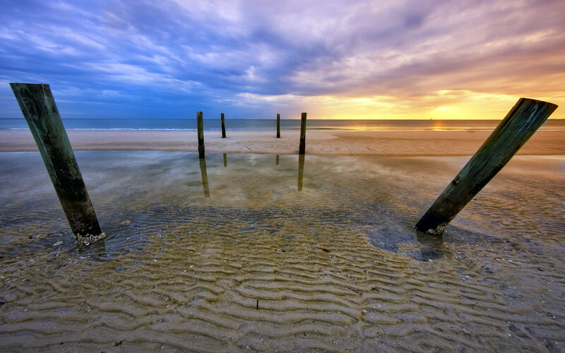 Wooden Posts on Beach — Blue, Dramatic