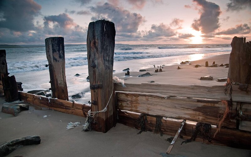 Wooden Posts on Beach — Brown, Serene, Sunset