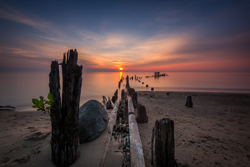 Wooden Posts on Beach — Orange, Serene, Sunset