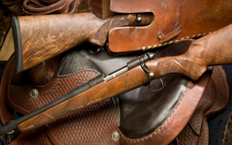 Wooden rifles in leather cases