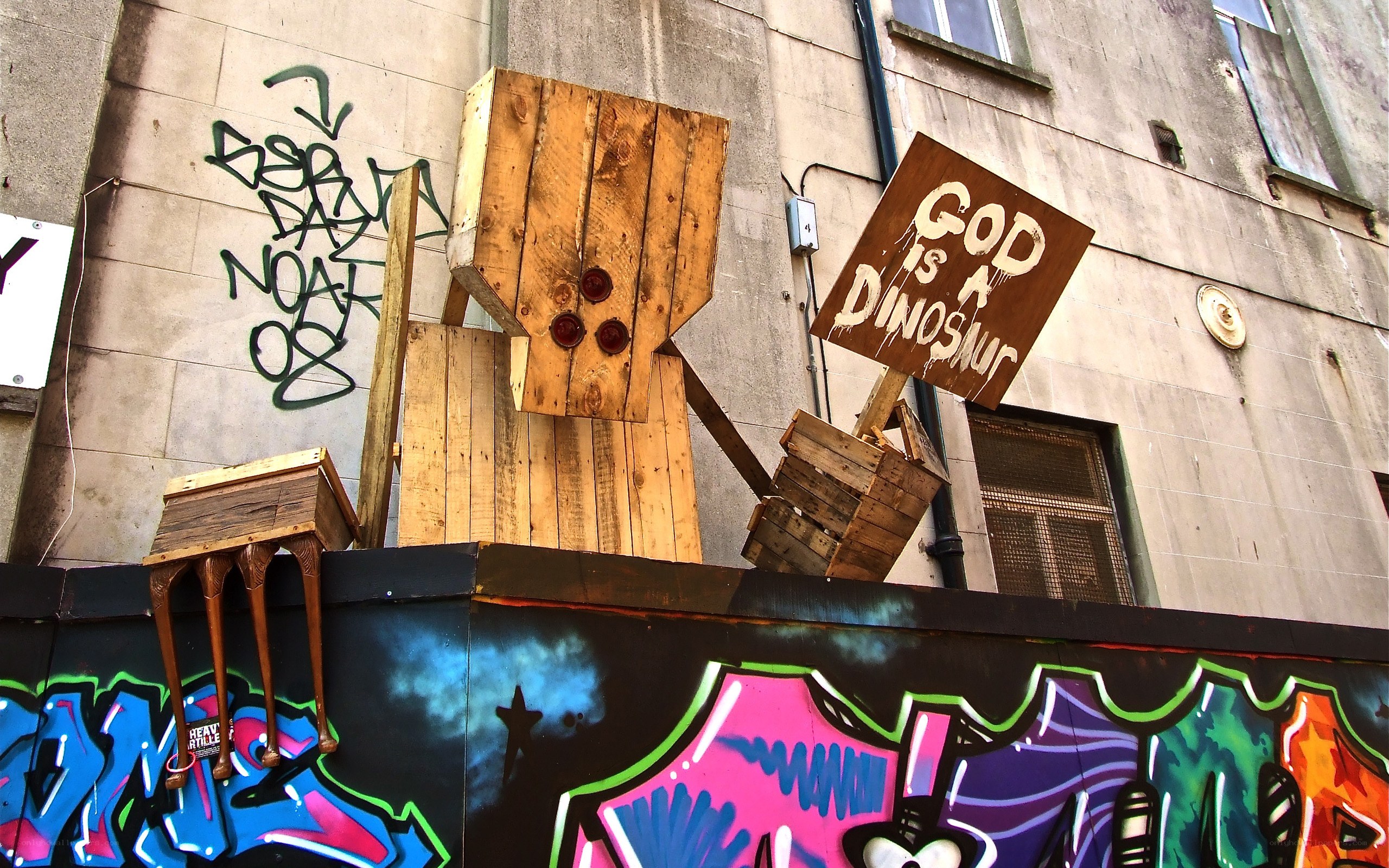 wooden sculpture with graffiti