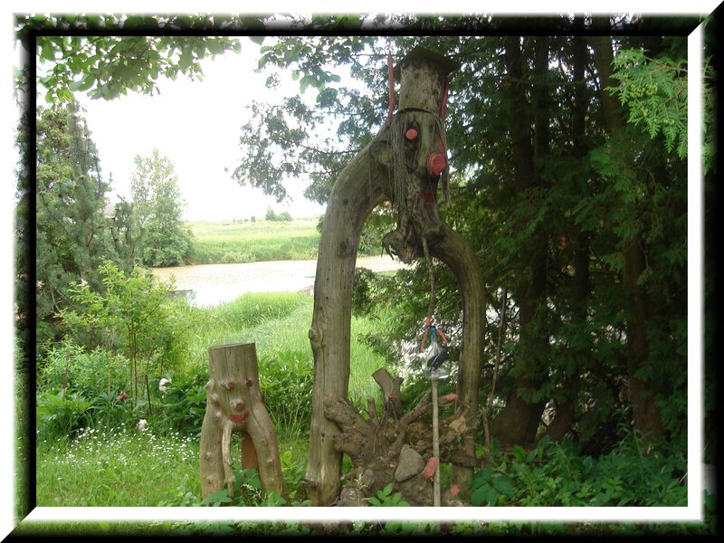 Wooden sculptures by a pond