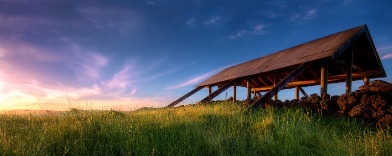 Wooden shelter on a grassy hill