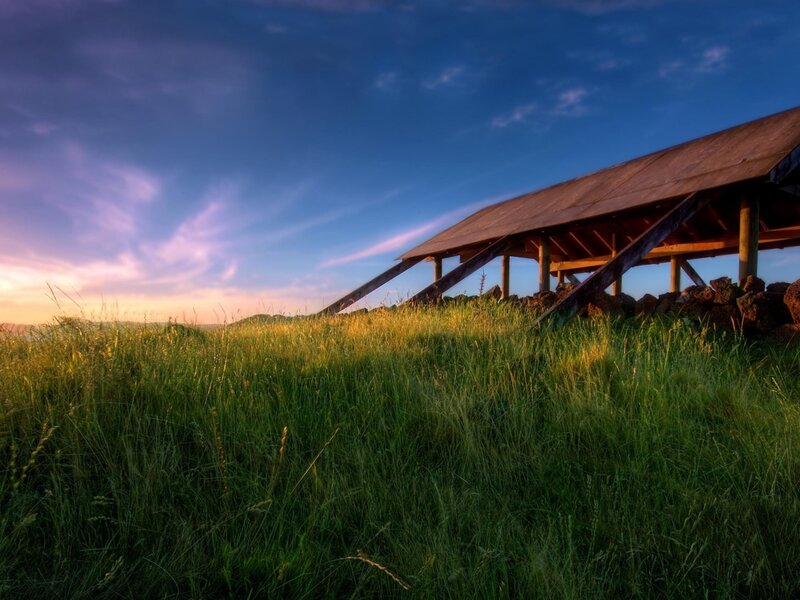 Wooden shelter on a grassy hill