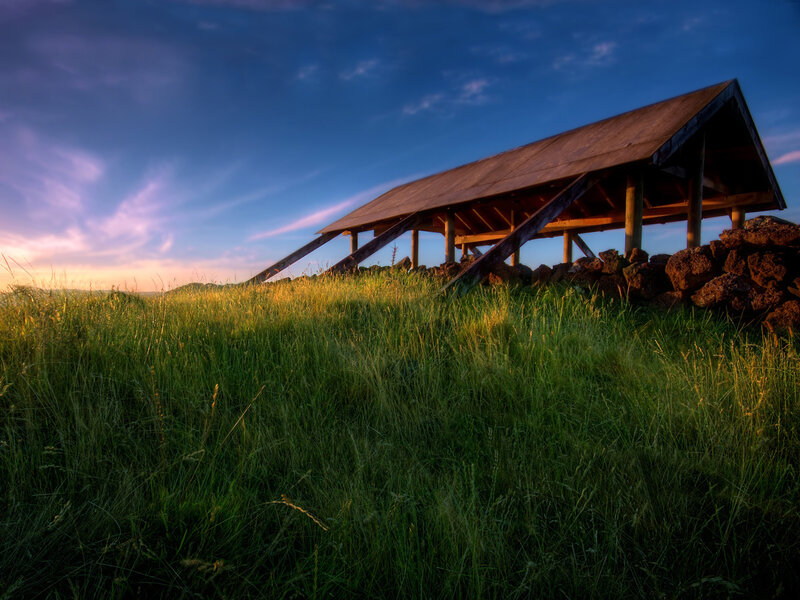 Wooden shelter on a grassy hill