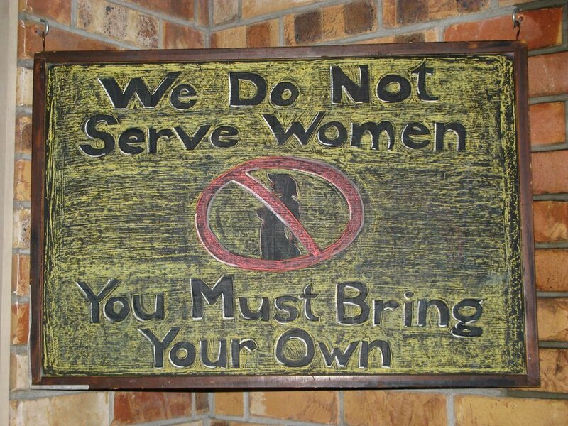 Wooden Sign on Brick Wall