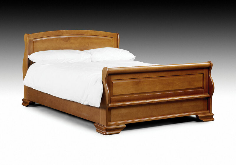 wooden sleigh bed with white linens