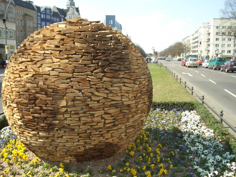 Wooden sphere sculpture in city