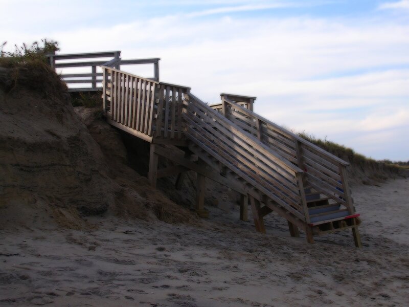 Wooden stairs on a sandy beach