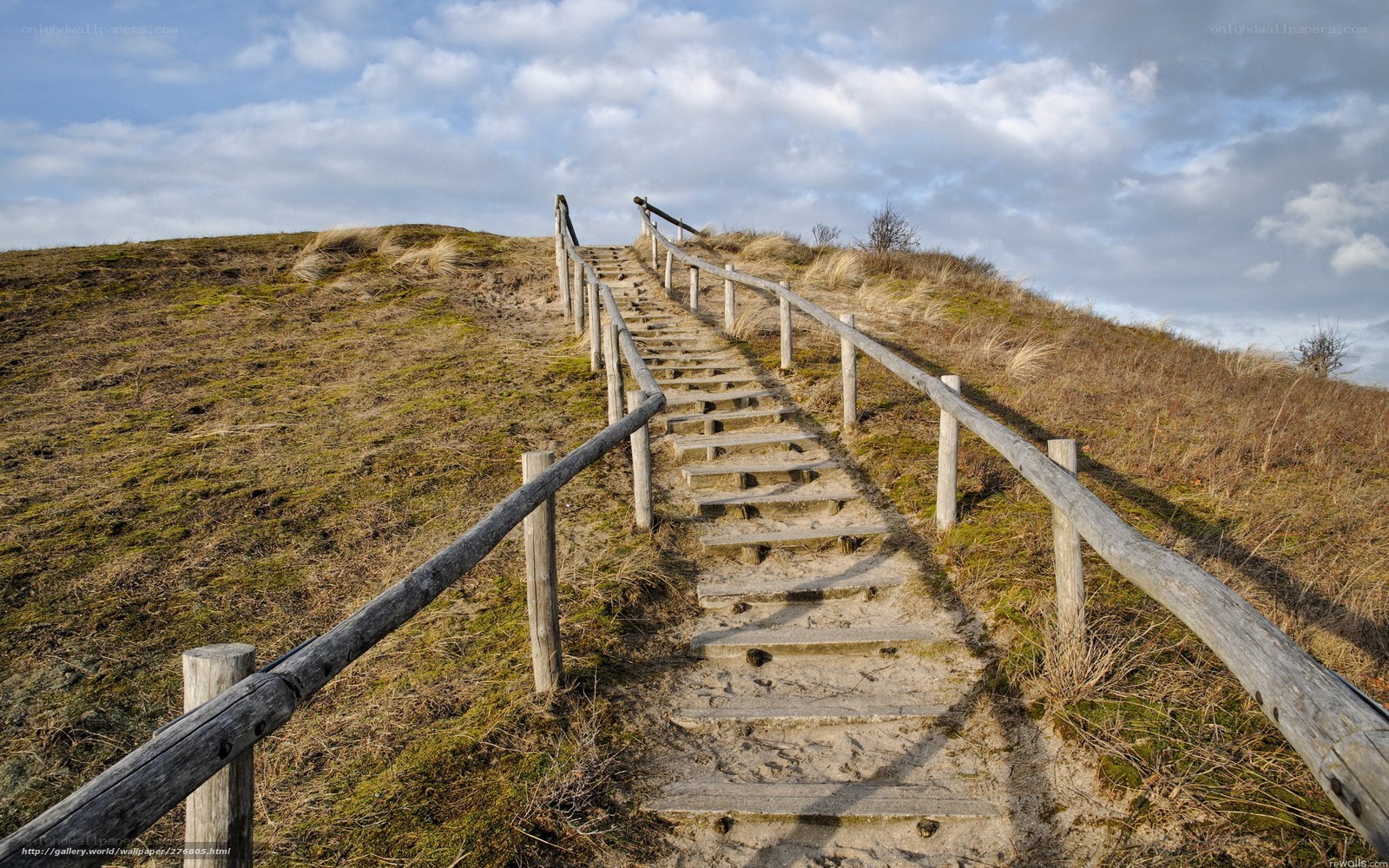 Wooden stairs on a sandy hill