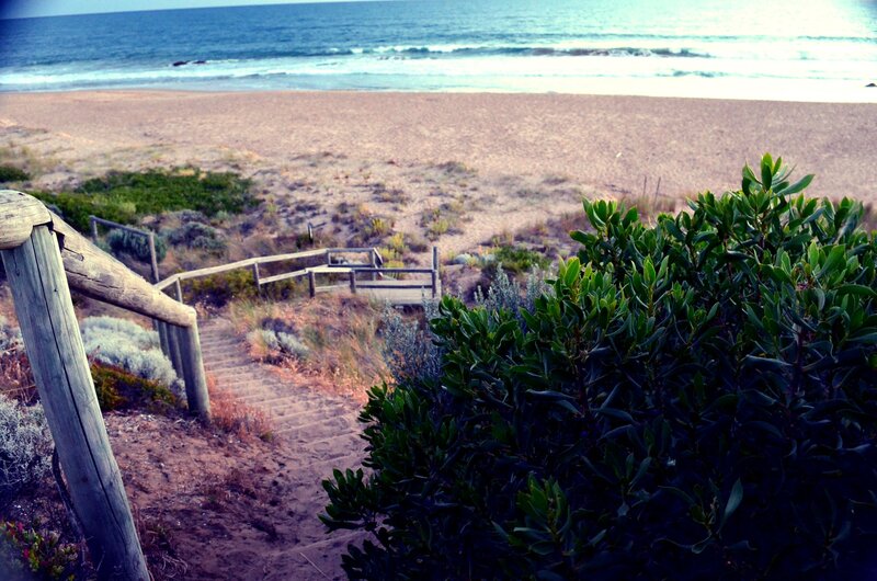 Wooden stairs to sandy beach