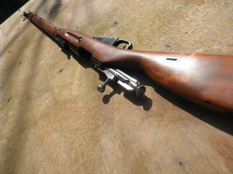 Wooden-stocked rifle on surface