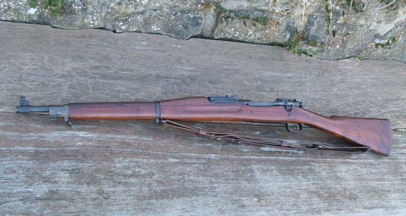 Wooden-stocked rifle on wood