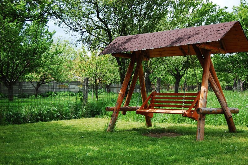 Wooden swing in a garden