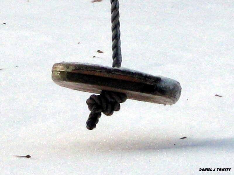wooden swing seat in snow