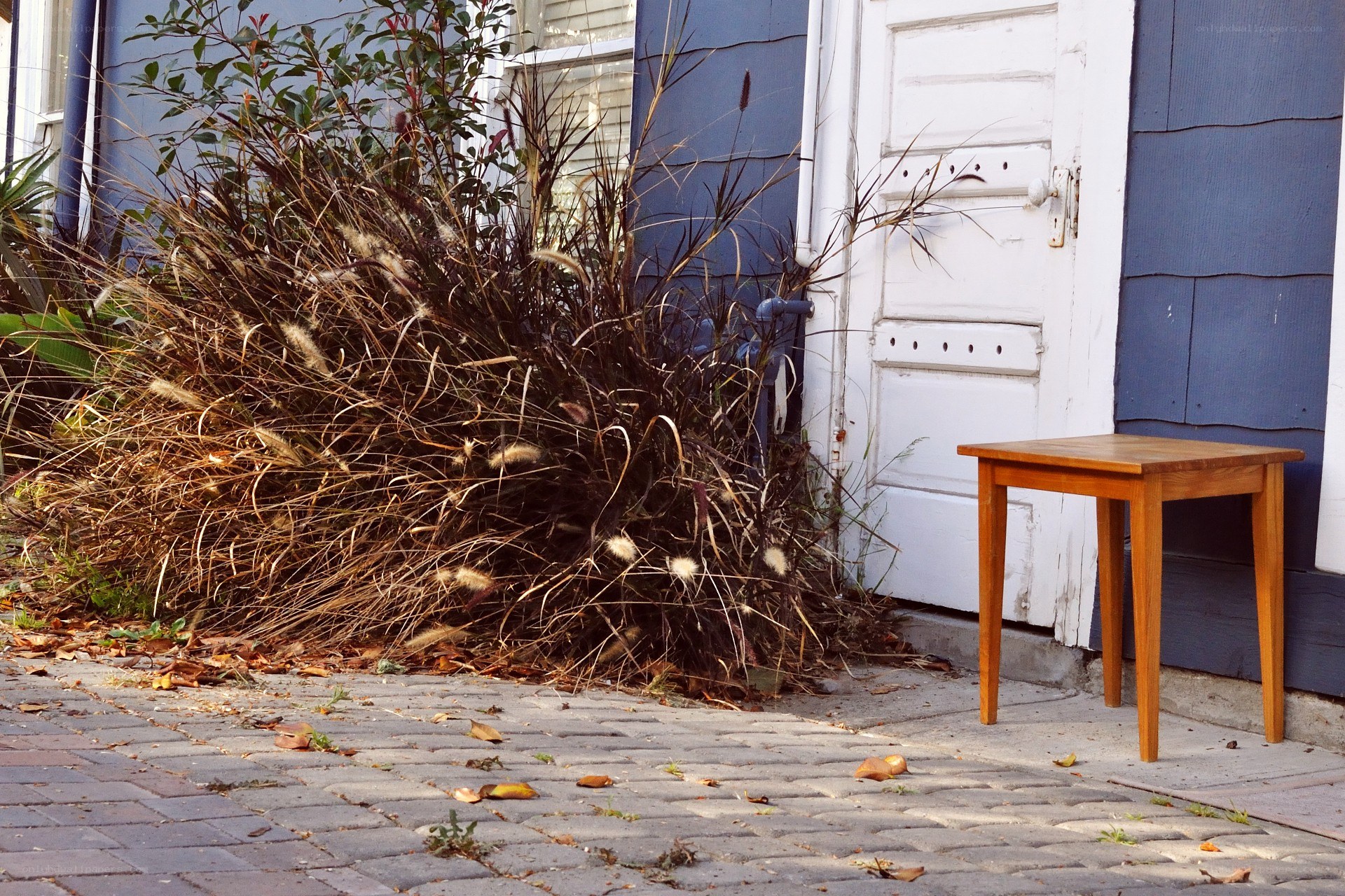 Wooden table beside a house