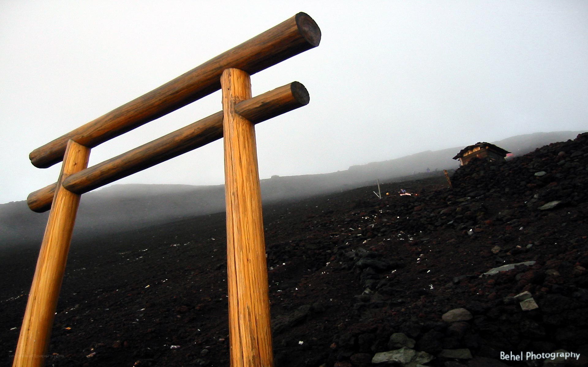 Wooden torii gate on volcanic field