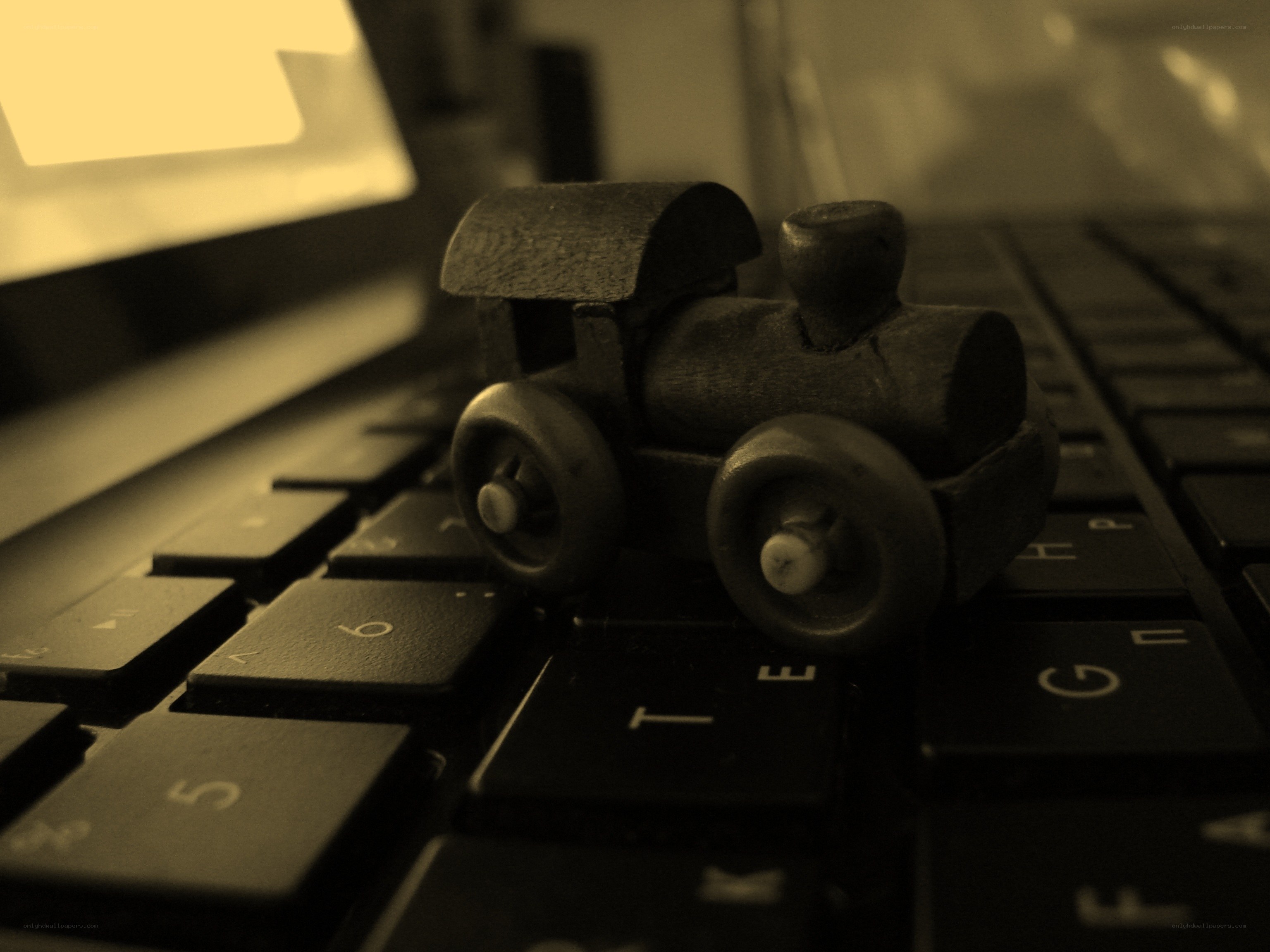 Wooden train on keyboard