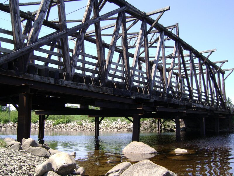 wooden truss bridge over river