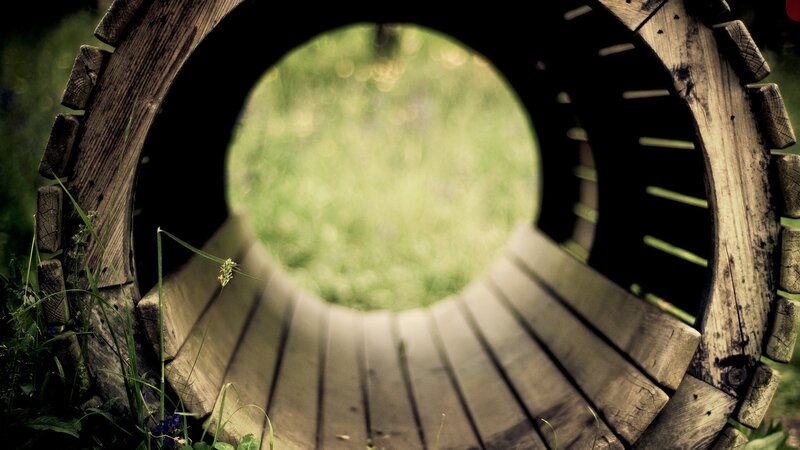 wooden tunnel to green field