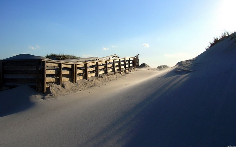 Wooden walkway on sandy dunes