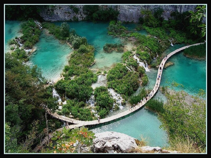 wooden walkway over turquoise lakes