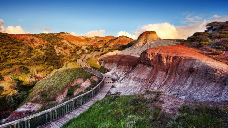 Wooden walkway through colorful hills