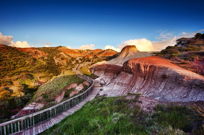 Wooden walkway through colorful hills