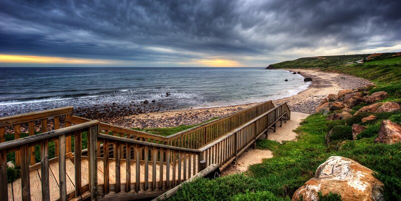 Wooden walkway to a rocky beach