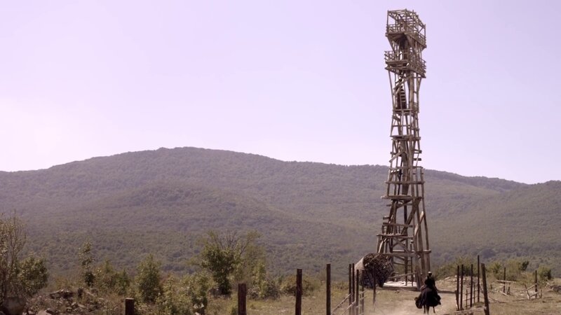 Wooden watchtower in rural landscape