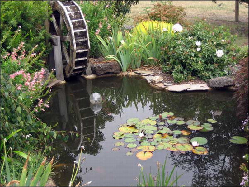 Wooden Waterwheel in Pond
