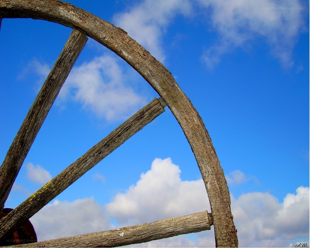 wooden wheel against blue sky