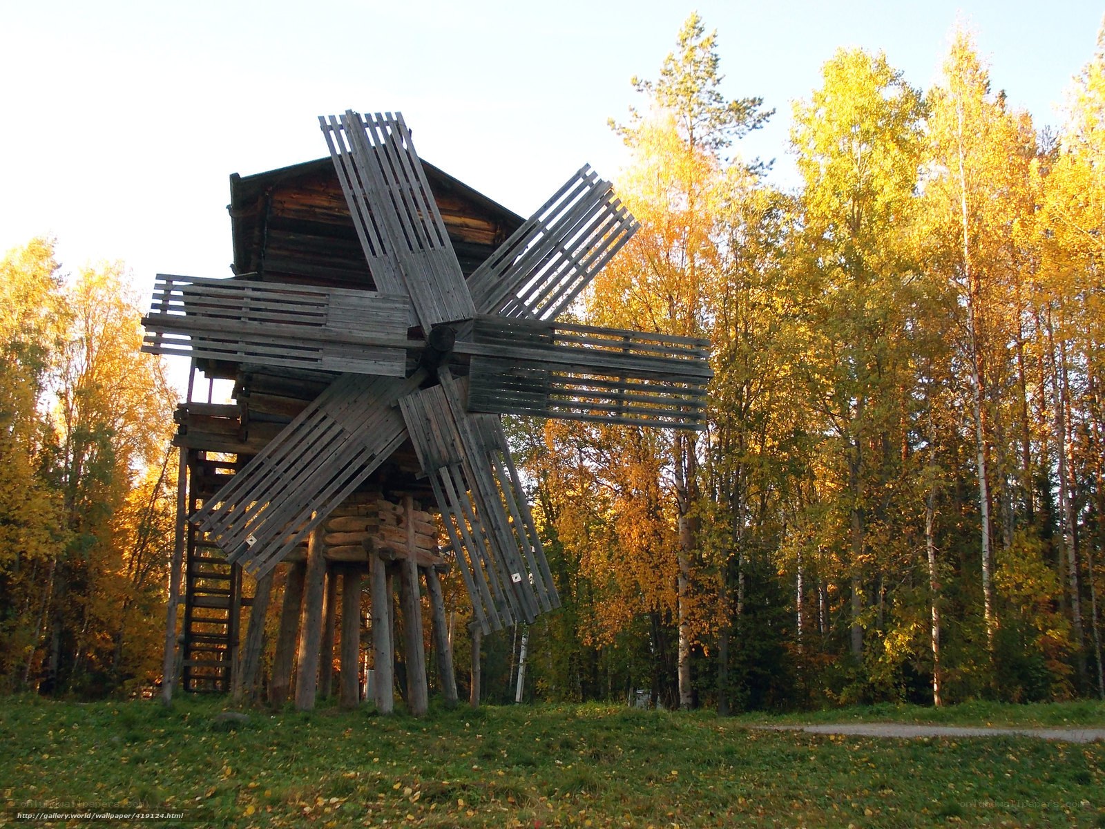 Wooden windmill in autumn forest