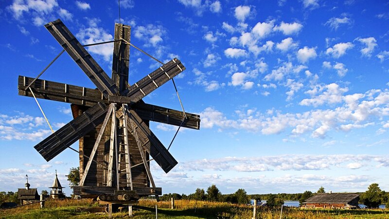 Wooden windmill in rural landscape