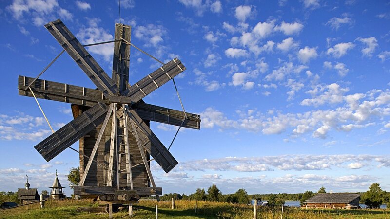 Wooden windmill in rural landscape