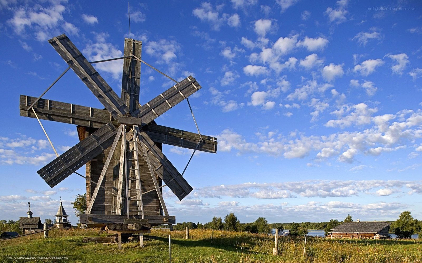 Wooden windmill in rural landscape