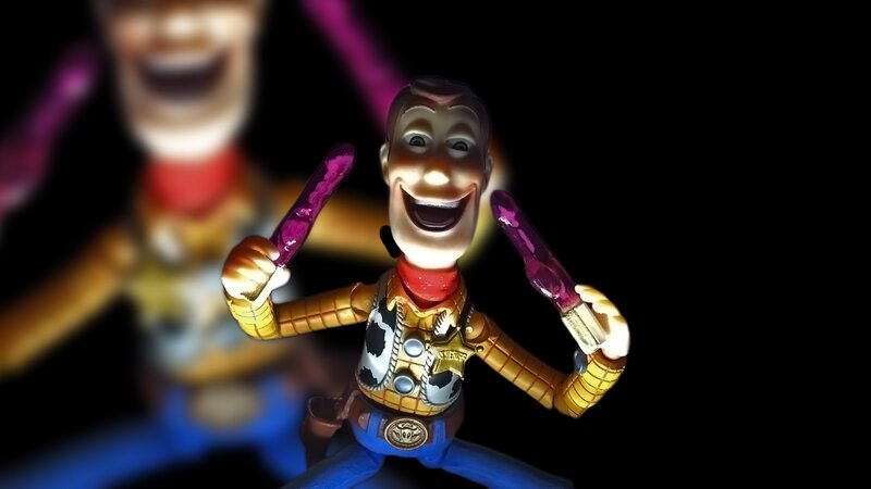 Woody toy figure with purple lightsabers