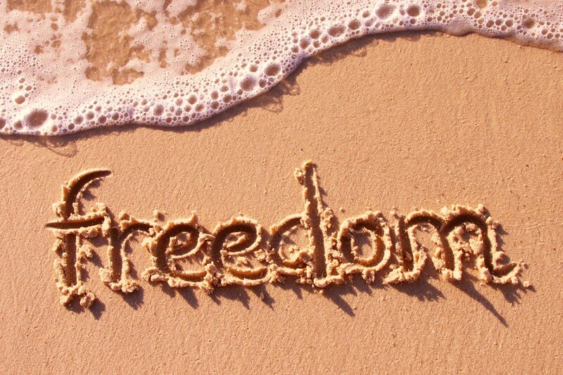 Word Freedom in Sand — Brown