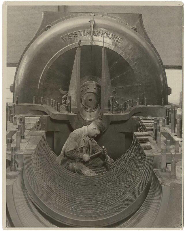 Worker assembling large industrial machine