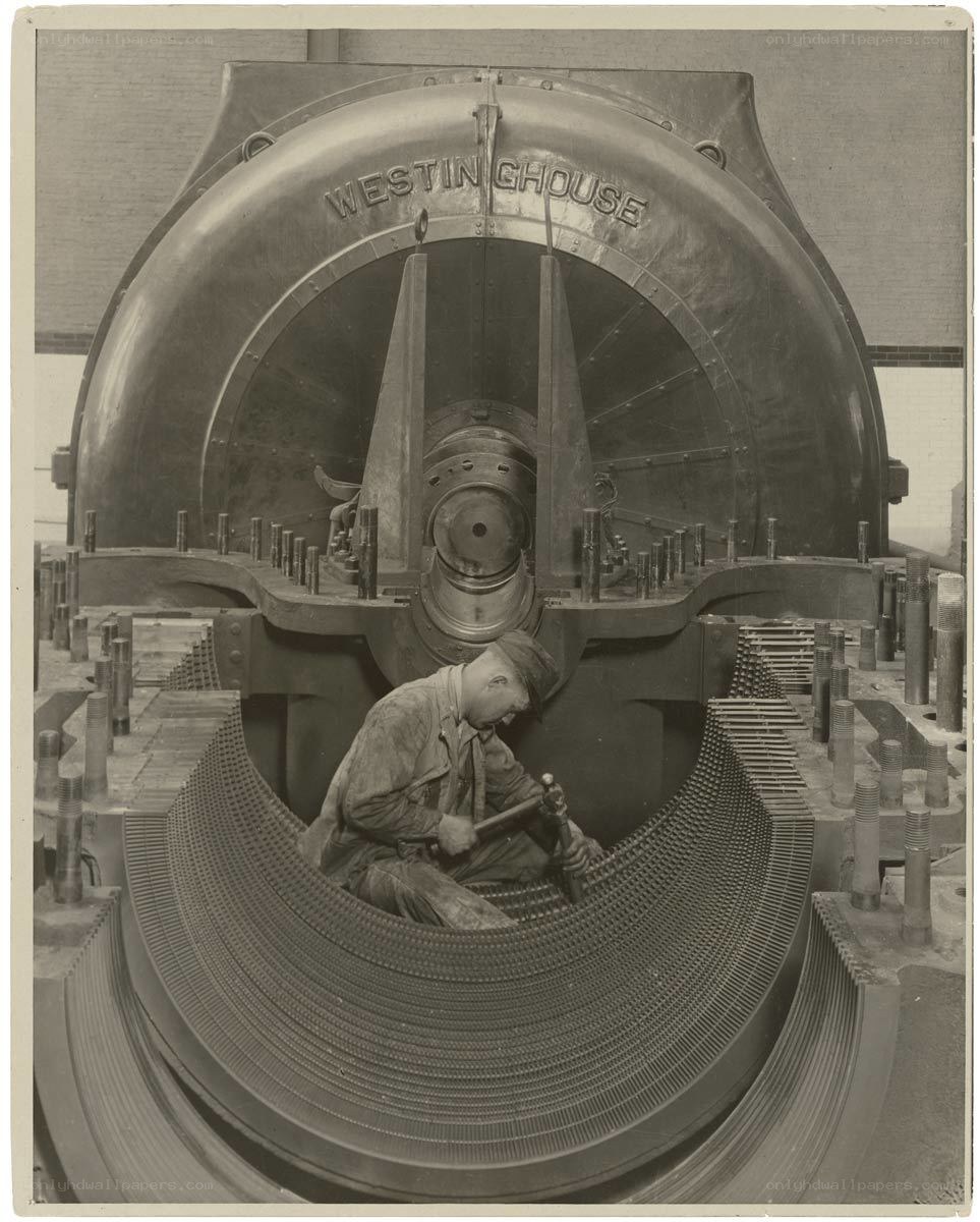 Worker assembling large industrial machine